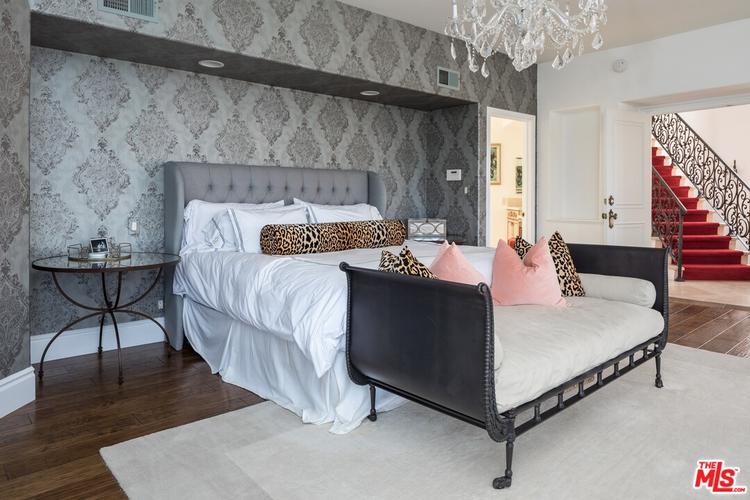 129 Roma Court Marina del Rey, CA 90292 - Photo 23 of 42 a bed sitting in a bedroom next to a window with a chandelier