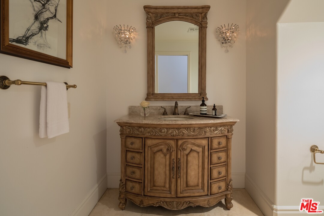 129 Roma Court Marina del Rey, CA 90292 - Photo 35 of 42 a bathroom with a granite countertop sink a mirror and a shower