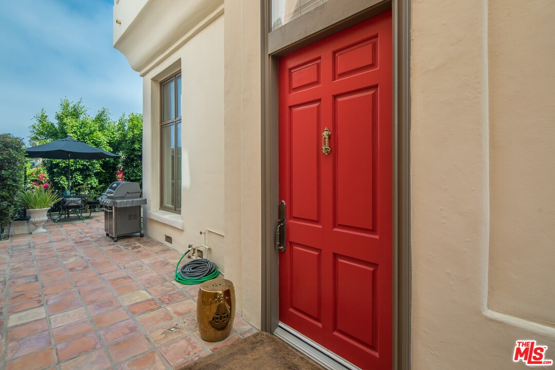129 Roma Court Marina del Rey, CA 90292 - Photo 5 of 42 a view of a door with a chair and table in a patio