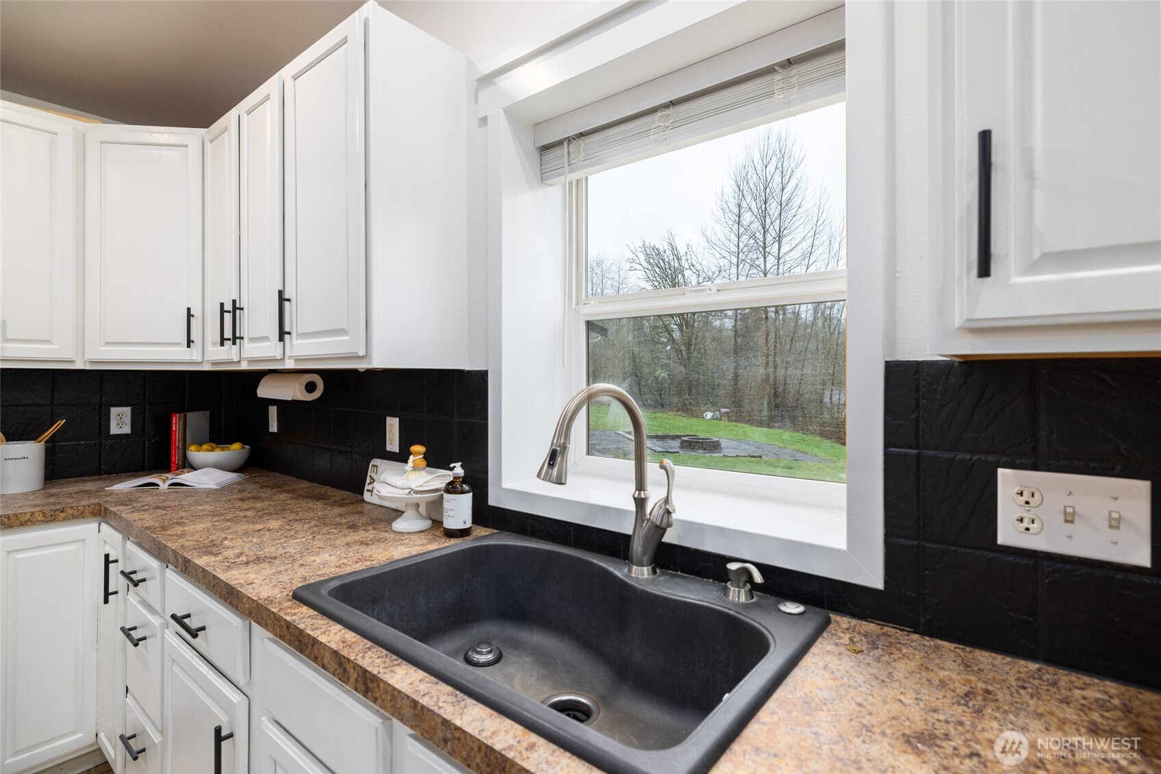 19366 Parson Creek Road Burlington, WA 98233 - Photo 11 of 31 a kitchen with granite countertop a stove a sink and a microwave