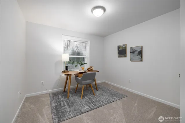 a workspace room with furniture and window