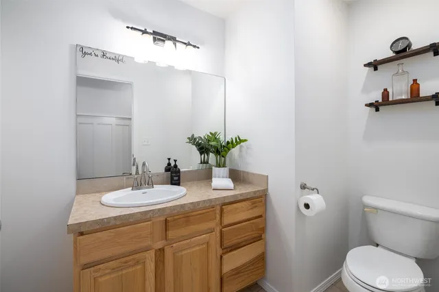 a bathroom with a sink a toilet and mirror