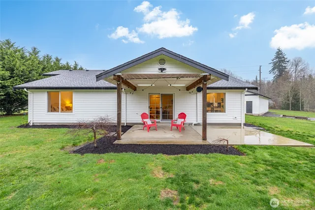 a front view of house with yard and outdoor seating
