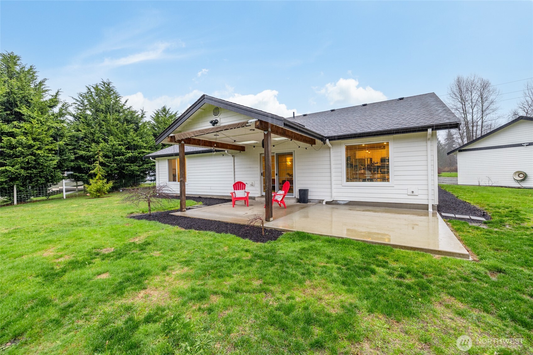 19366 Parson Creek Road Burlington, WA 98233 - Photo 23 of 31 a view of a house with a yard and a patio