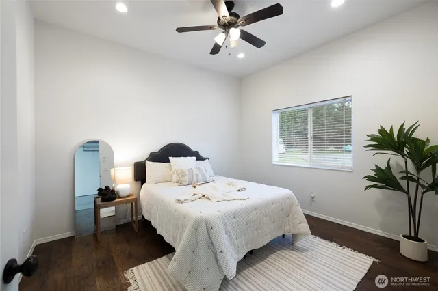 a bedroom with double bed and a window