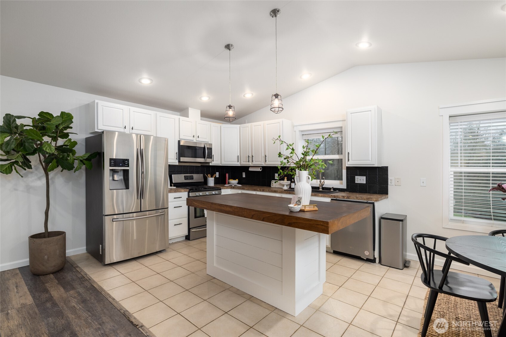 19366 Parson Creek Road Burlington, WA 98233 - Photo 8 of 31 a kitchen with refrigerator and chairs