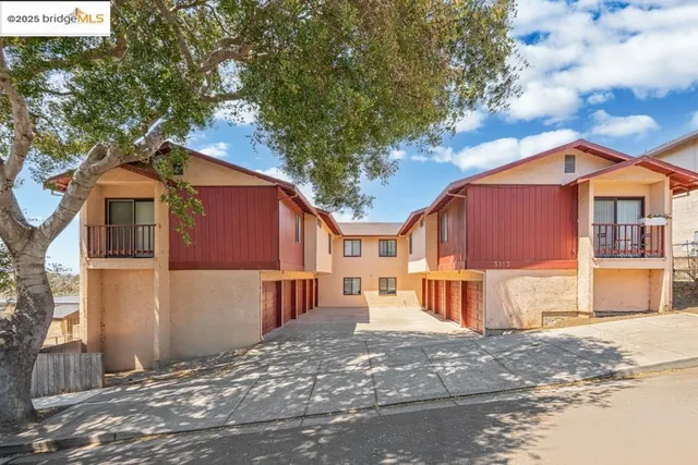 a front view of a house with a yard covered in snow