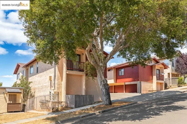 a view of a street with a tree