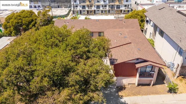 a aerial view of a house with a yard and sitting area