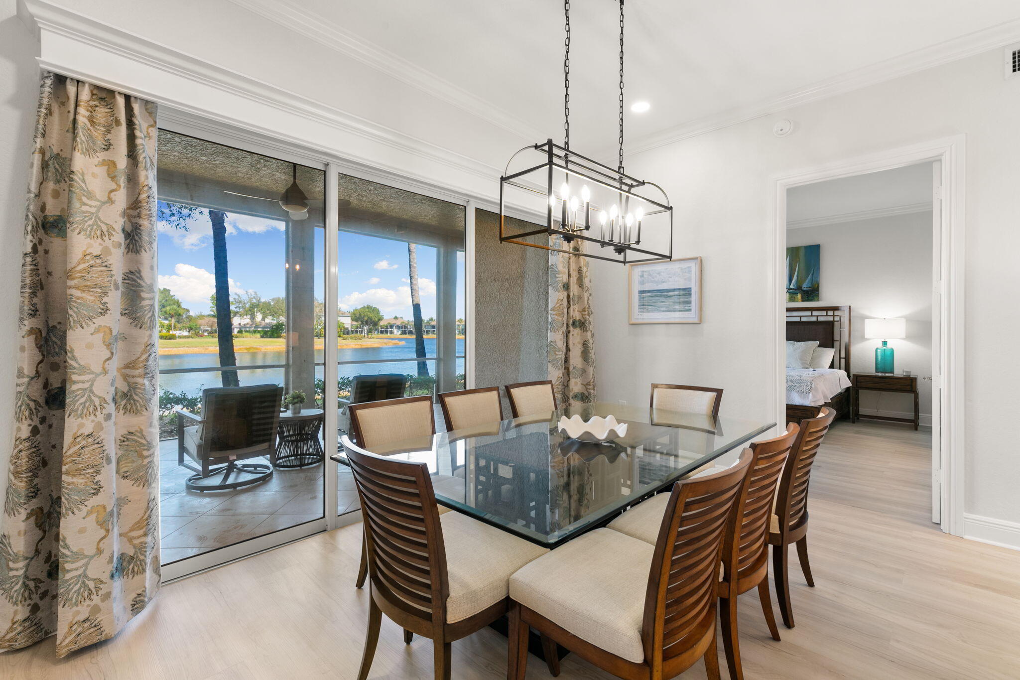 9213 Museo Circle, Unit 103 Naples, FL 34114 - Photo 11 of 47 a dining room with furniture a chandelier and wooden floor