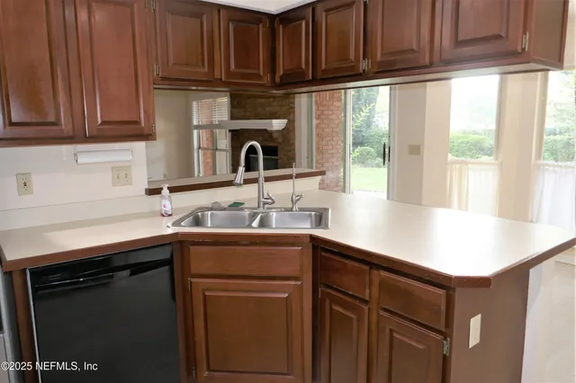 a kitchen with stainless steel appliances granite countertop a sink stove and cabinets