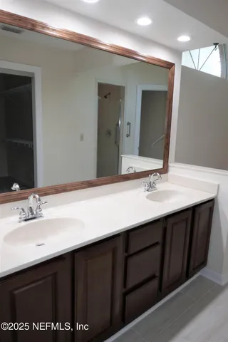 a bathroom with a sink double vanity and a mirror