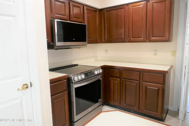 a kitchen with a stove and a microwave
