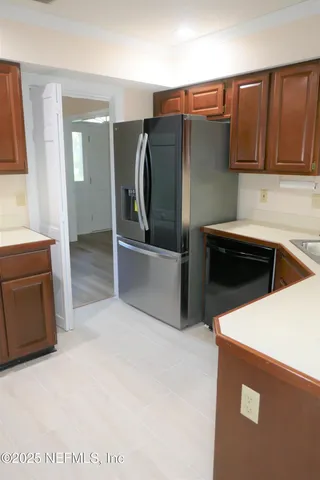 a kitchen with stainless steel appliances a refrigerator sink and cabinets