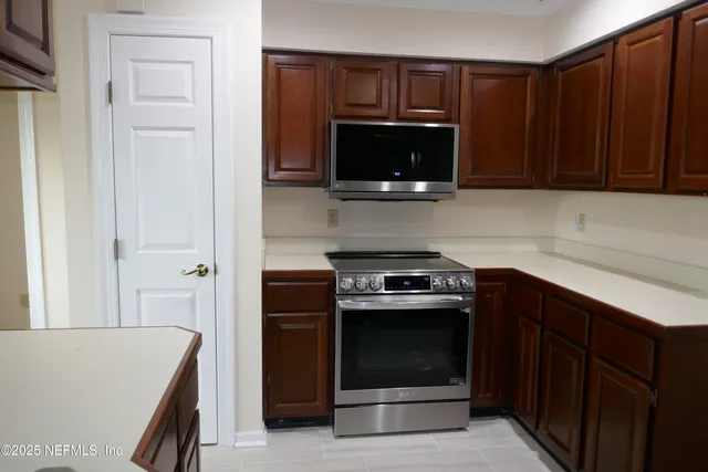a kitchen with a stove and a microwave