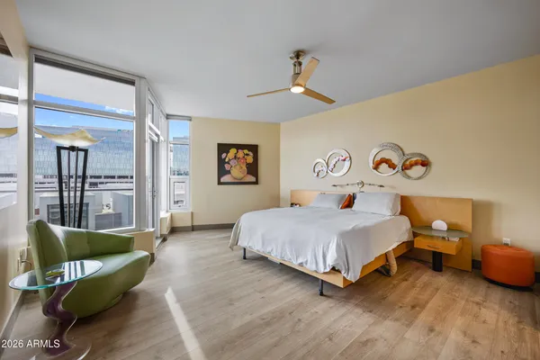 a bedroom with a bed and a large mirror