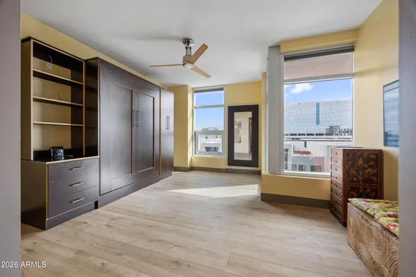 a bedroom with a bed and a view of kitchen