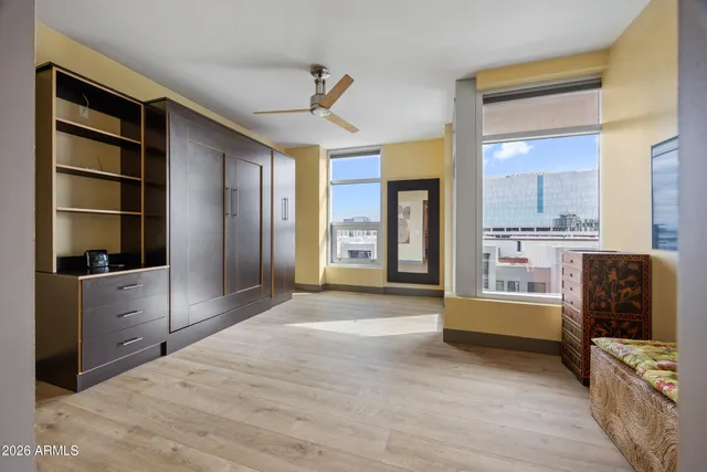 a bedroom with a bed and a view of kitchen