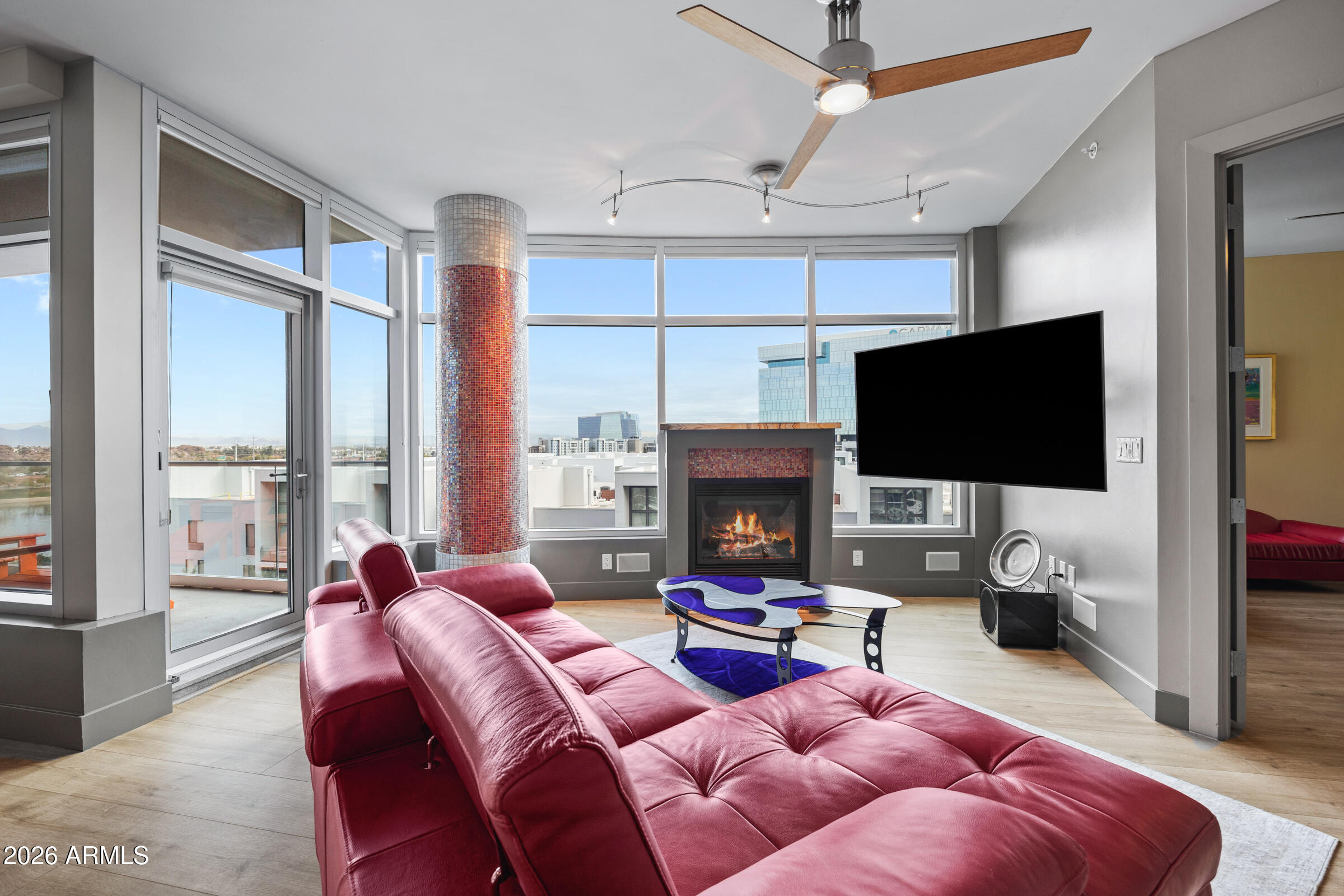 140 East Rio Salado Parkway, Unit 610 Tempe, AZ 85281 - Photo 2 of 57 a living room with furniture a flat screen tv and a floor to ceiling window