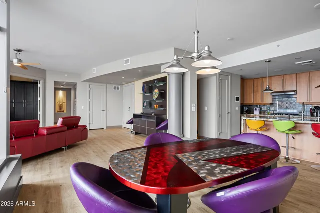 a room with kitchen island granite countertop a stove and a refrigerator