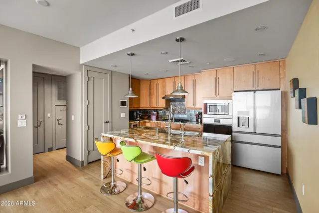 a kitchen with kitchen island granite countertop a stove a sink and a refrigerator