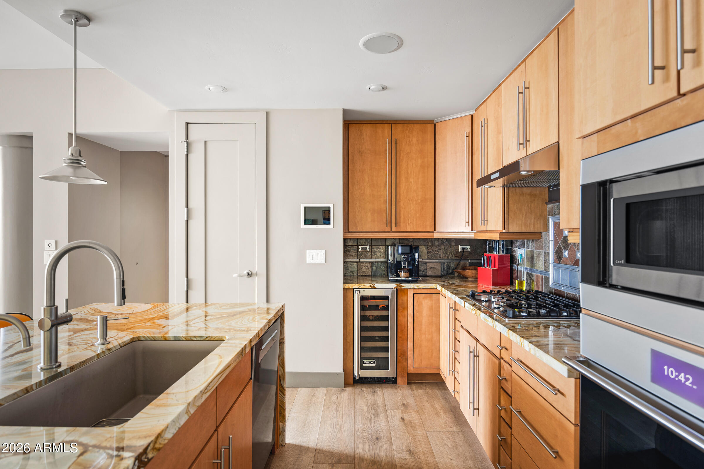 140 East Rio Salado Parkway, Unit 610 Tempe, AZ 85281 - Photo 8 of 57 a kitchen with kitchen island granite countertop a stove a sink and a refrigerator