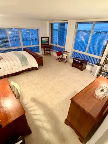 a bathroom with a sink a toilet a mirror and window