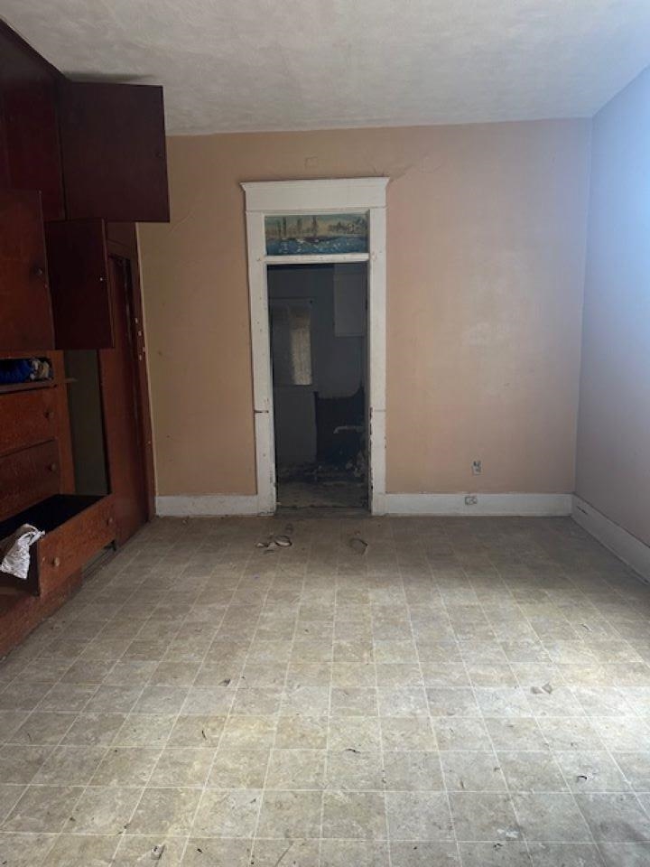 942 Roland Street, Unit 3 Memphis, TN 38114 - Photo 7 of 13 Unfurnished living room featuring a textured ceiling