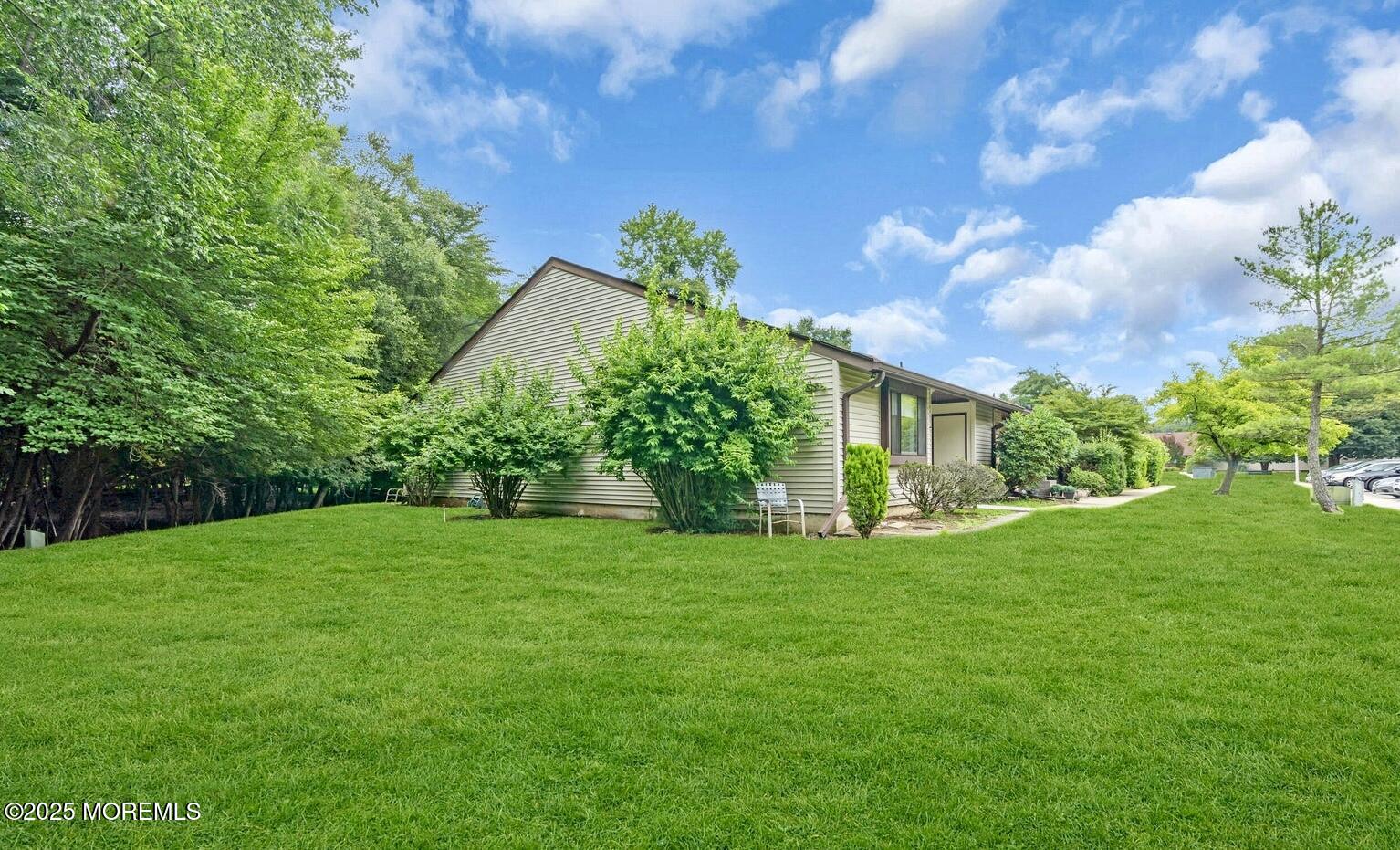 70 Overlook Way, Unit A Manalapan, NJ 07726 - Photo 11 of 13 a view of a backyard with a garden