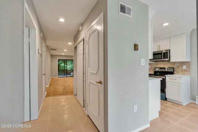 a view of a kitchen with a sink and dishwasher a refrigerator a window