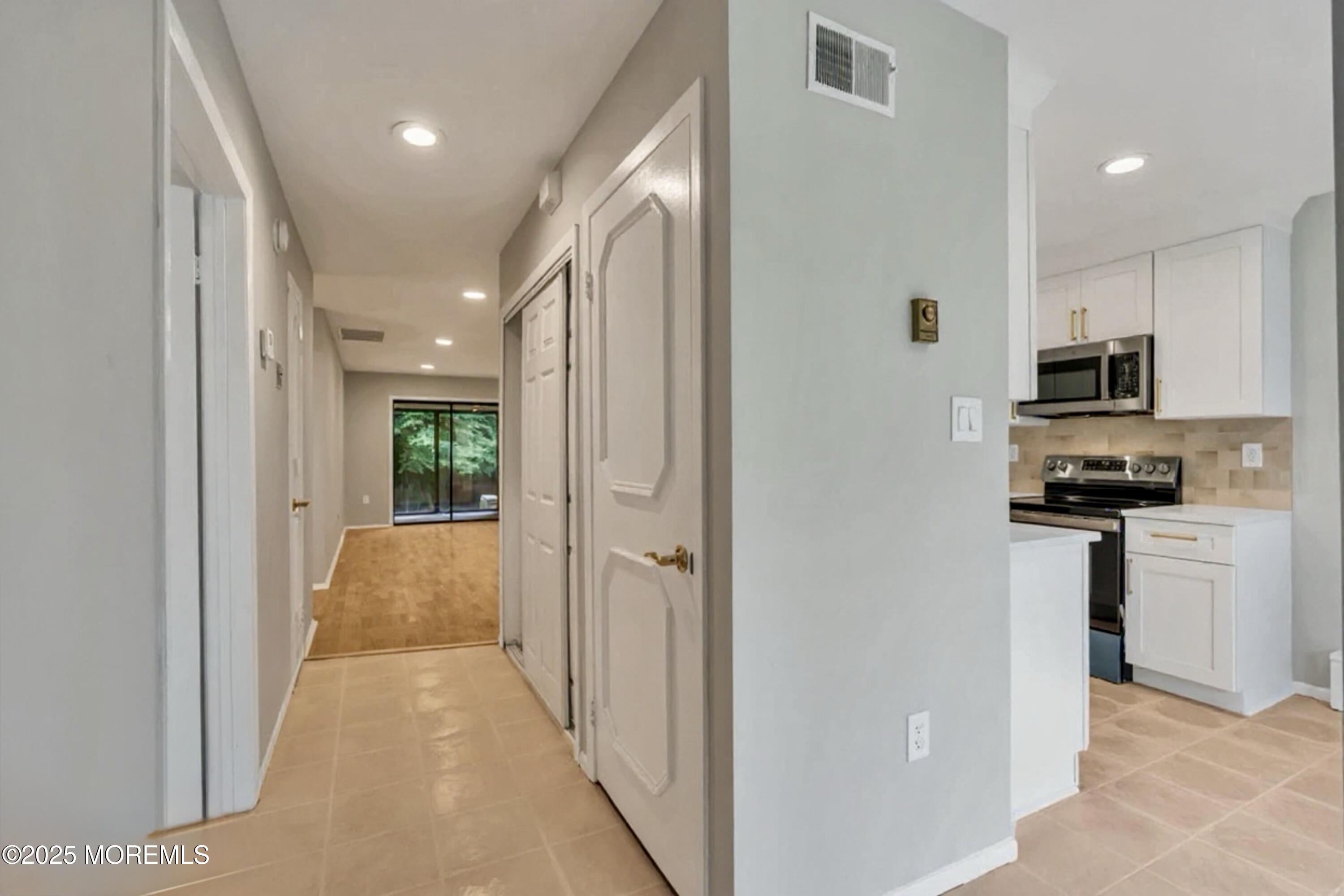 70 Overlook Way, Unit A Manalapan, NJ 07726 - Photo 3 of 13 a view of a kitchen with a sink and dishwasher a refrigerator a window