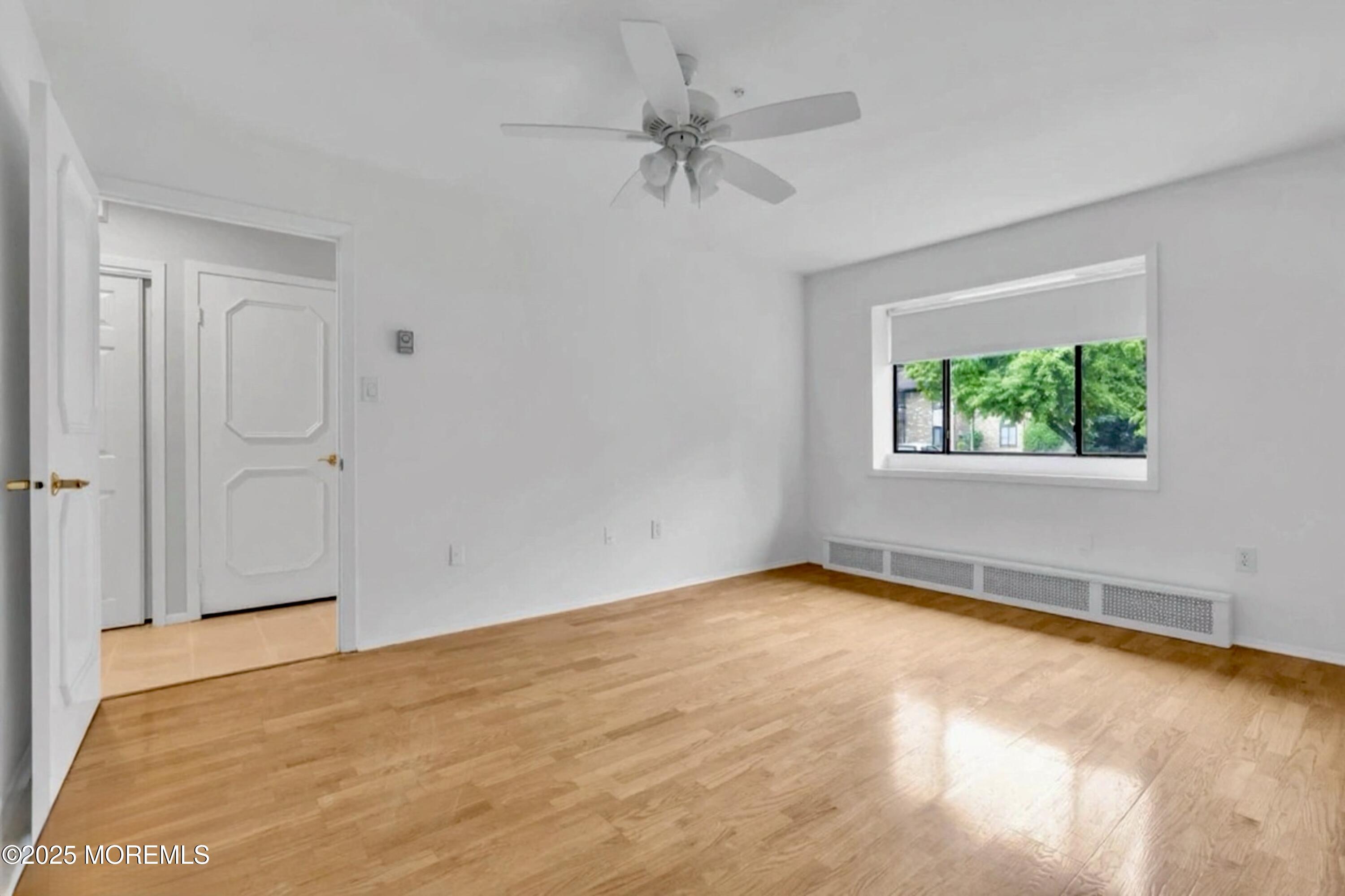 70 Overlook Way, Unit A Manalapan, NJ 07726 - Photo 6 of 13 a view of an empty room with a window