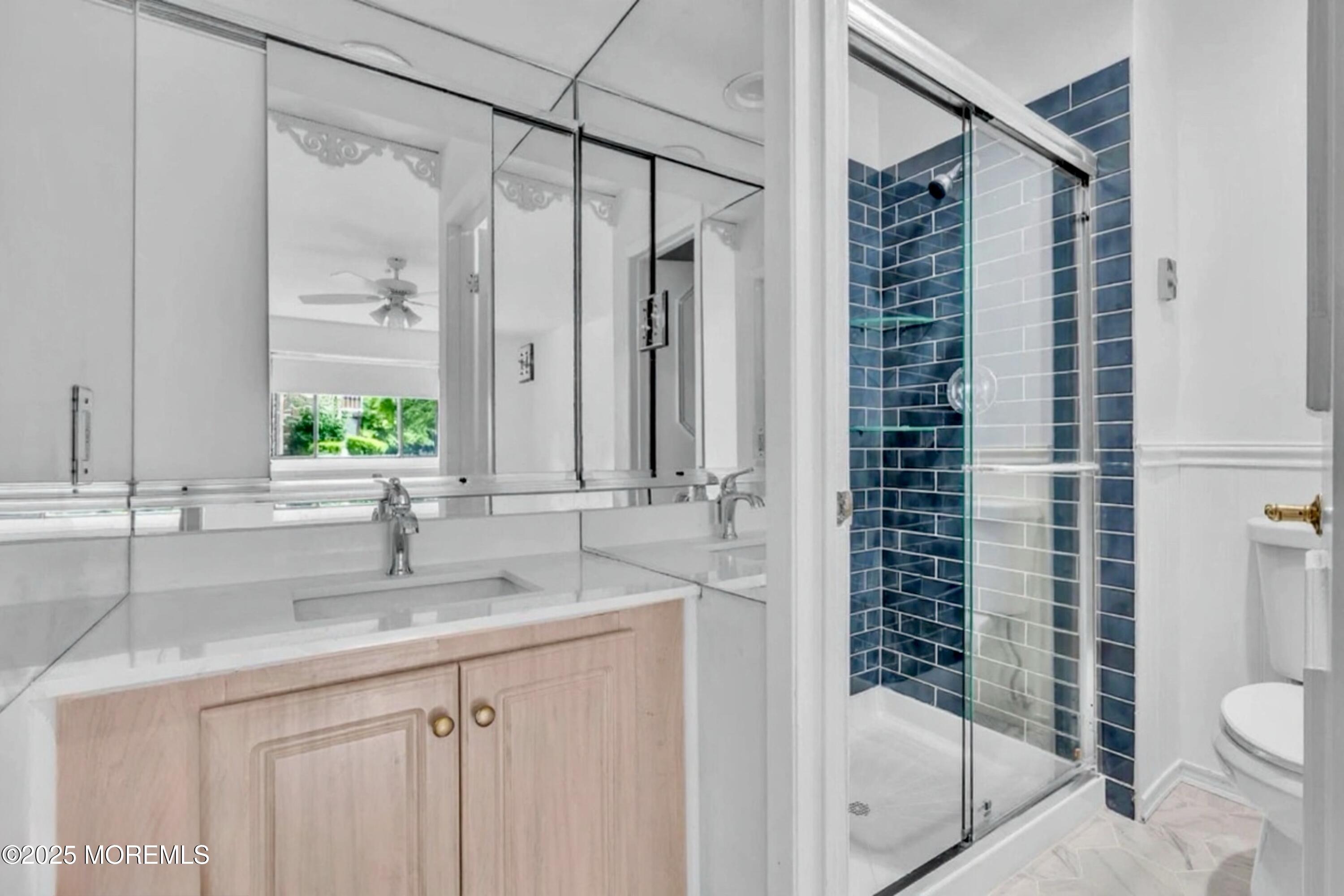 70 Overlook Way, Unit A Manalapan, NJ 07726 - Photo 7 of 13 a bathroom with a granite countertop sink a toilet and shower