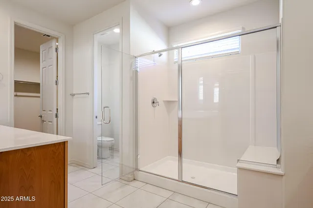 a bathroom with a glass shower door