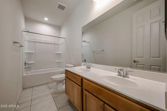a bathroom with a granite countertop sink a toilet a bathtub and shower