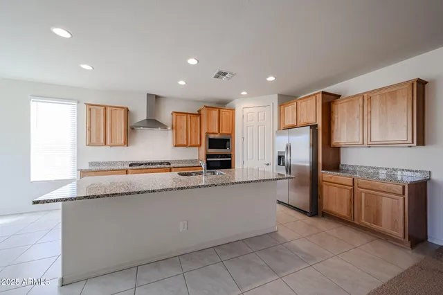 a large kitchen with stainless steel appliances lots of counter top space