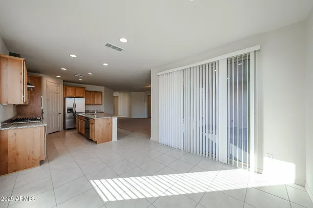 a view of kitchen with sink and refrigerator