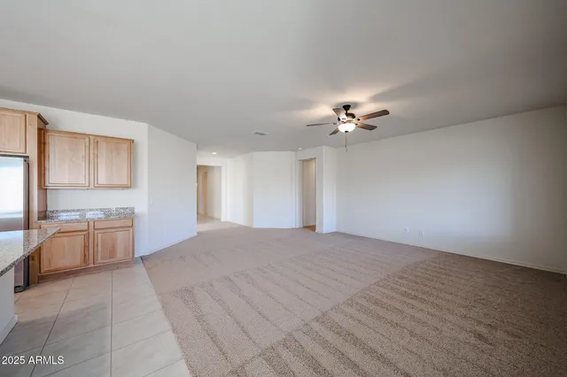 a view of a livingroom with a ceiling fan and window