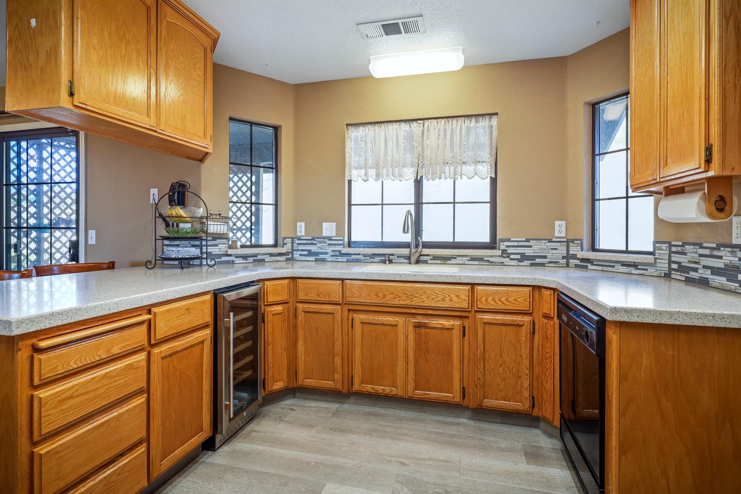2 Katelyn Court Valley Springs, CA 95252 - Photo 22 of 98 a kitchen with stainless steel appliances granite countertop wooden cabinets a sink and a large window