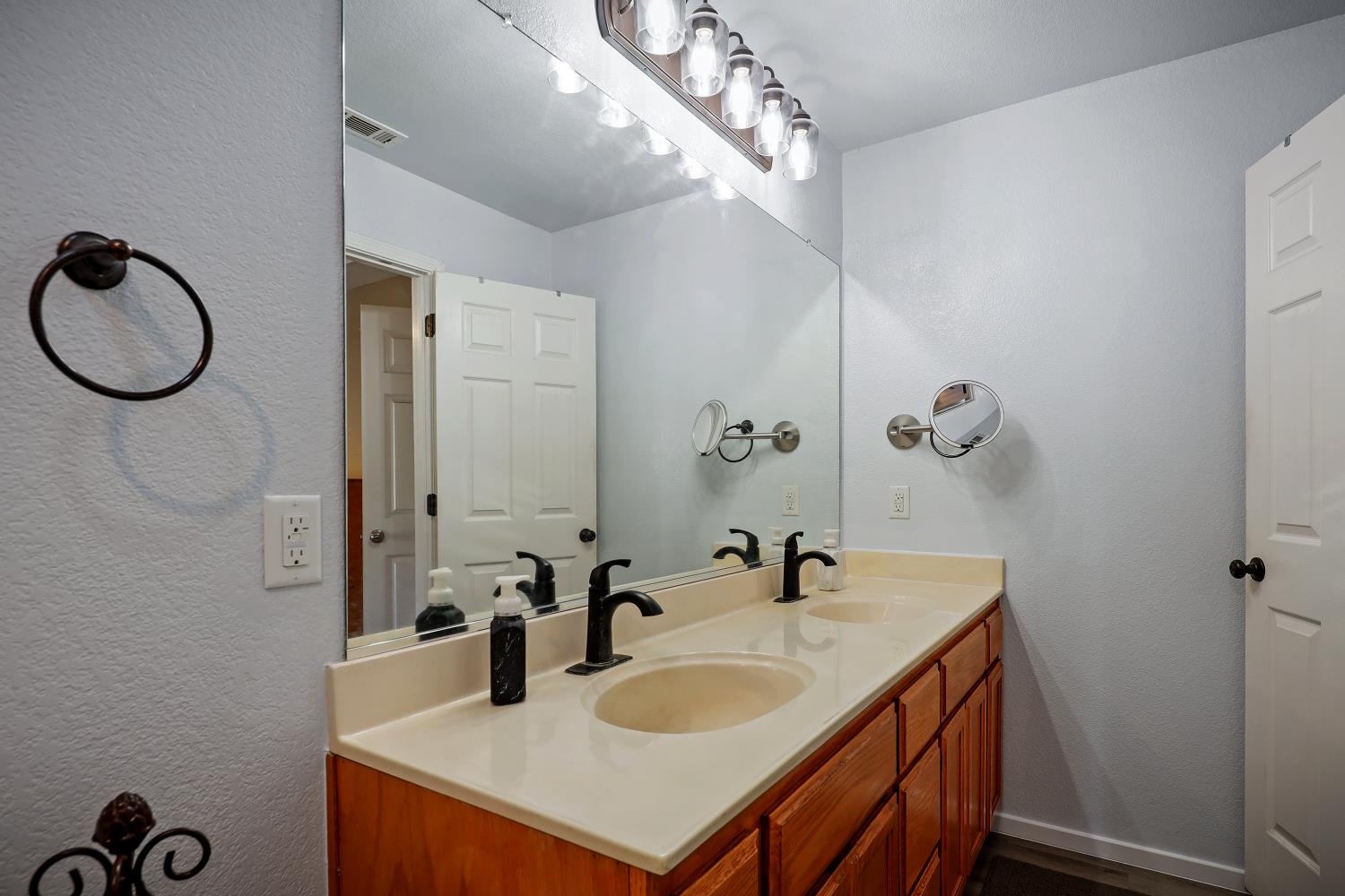 2 Katelyn Court Valley Springs, CA 95252 - Photo 38 of 98 a bathroom with a granite countertop sink and a mirror