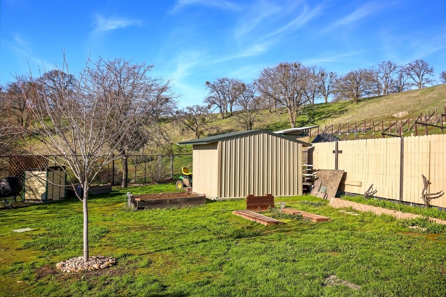 2 Katelyn Court Valley Springs, CA 95252 - Photo 47 of 98 a backyard of a house with lots of green space and outdoor seating