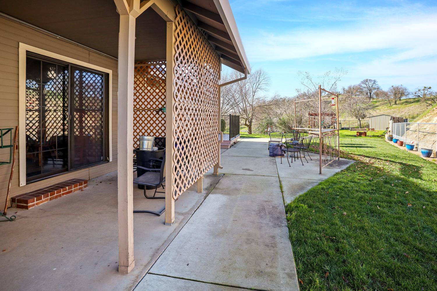 2 Katelyn Court Valley Springs, CA 95252 - Photo 59 of 98 a view of a patio with couches and table and chairs and floor to ceiling window