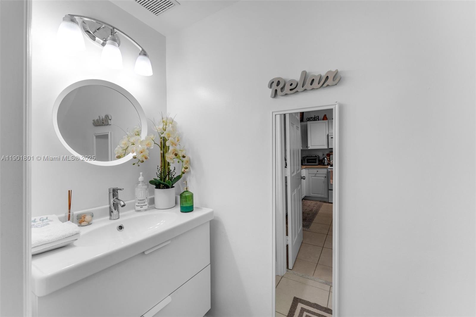 1595 Northeast 33rd Road, Unit 1123 Homestead, FL 33033 - Photo 13 of 34 a bathroom with a sink and a mirror