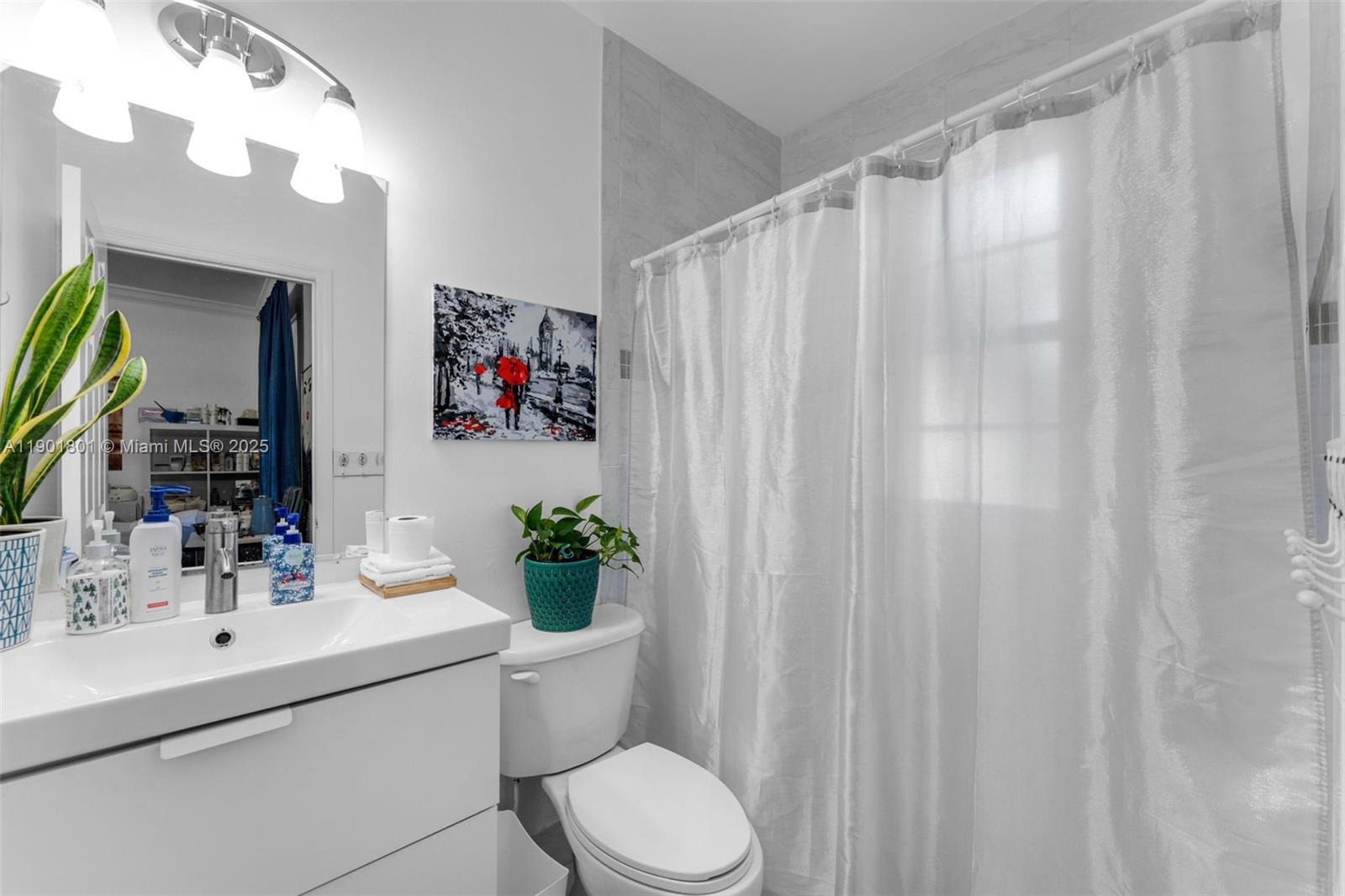 1595 Northeast 33rd Road, Unit 1123 Homestead, FL 33033 - Photo 16 of 34 a bathroom with a sink vanity mirror and toilet