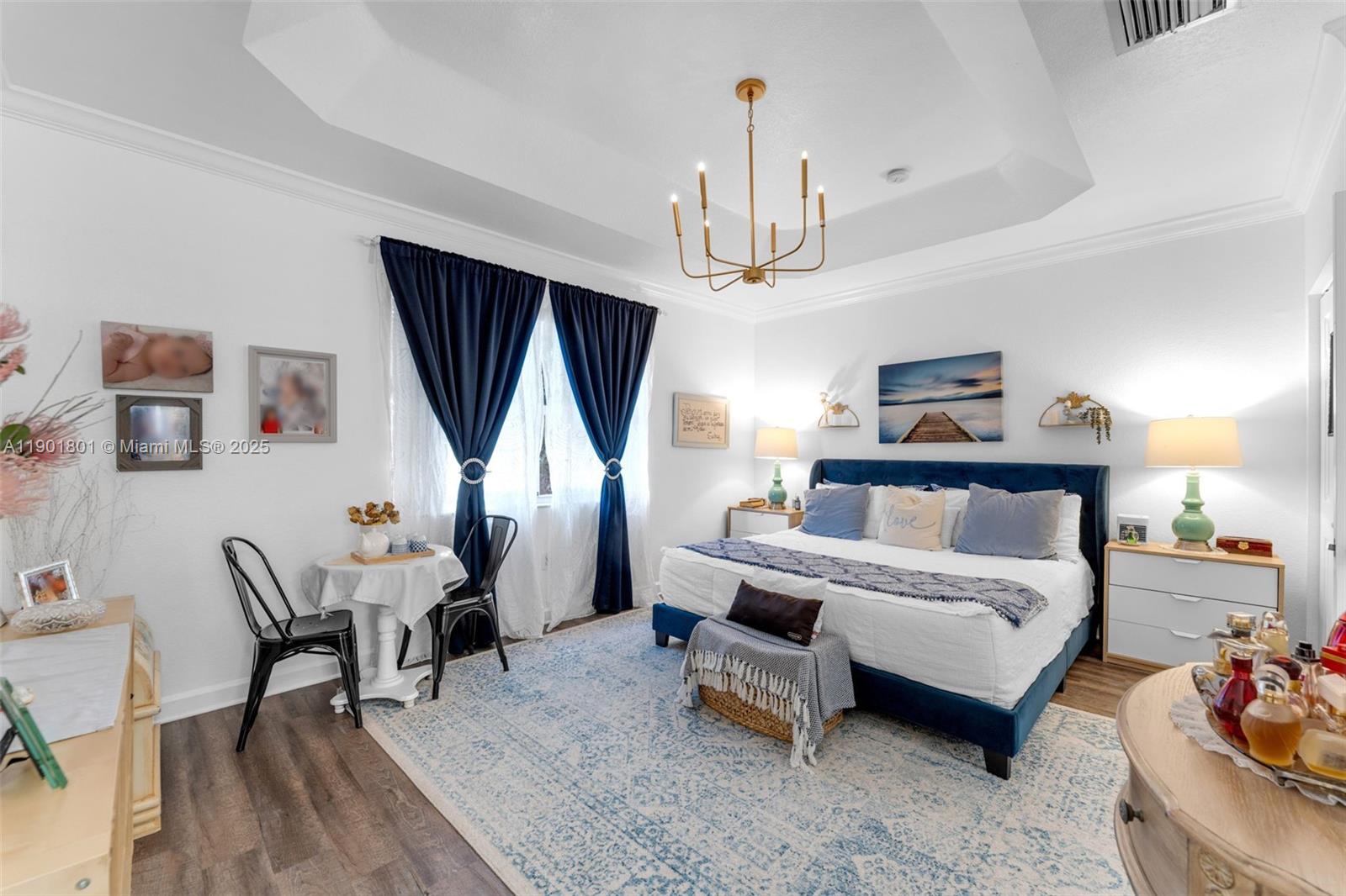 1595 Northeast 33rd Road, Unit 1123 Homestead, FL 33033 - Photo 17 of 34 a bedroom with a bed a couch and chandelier