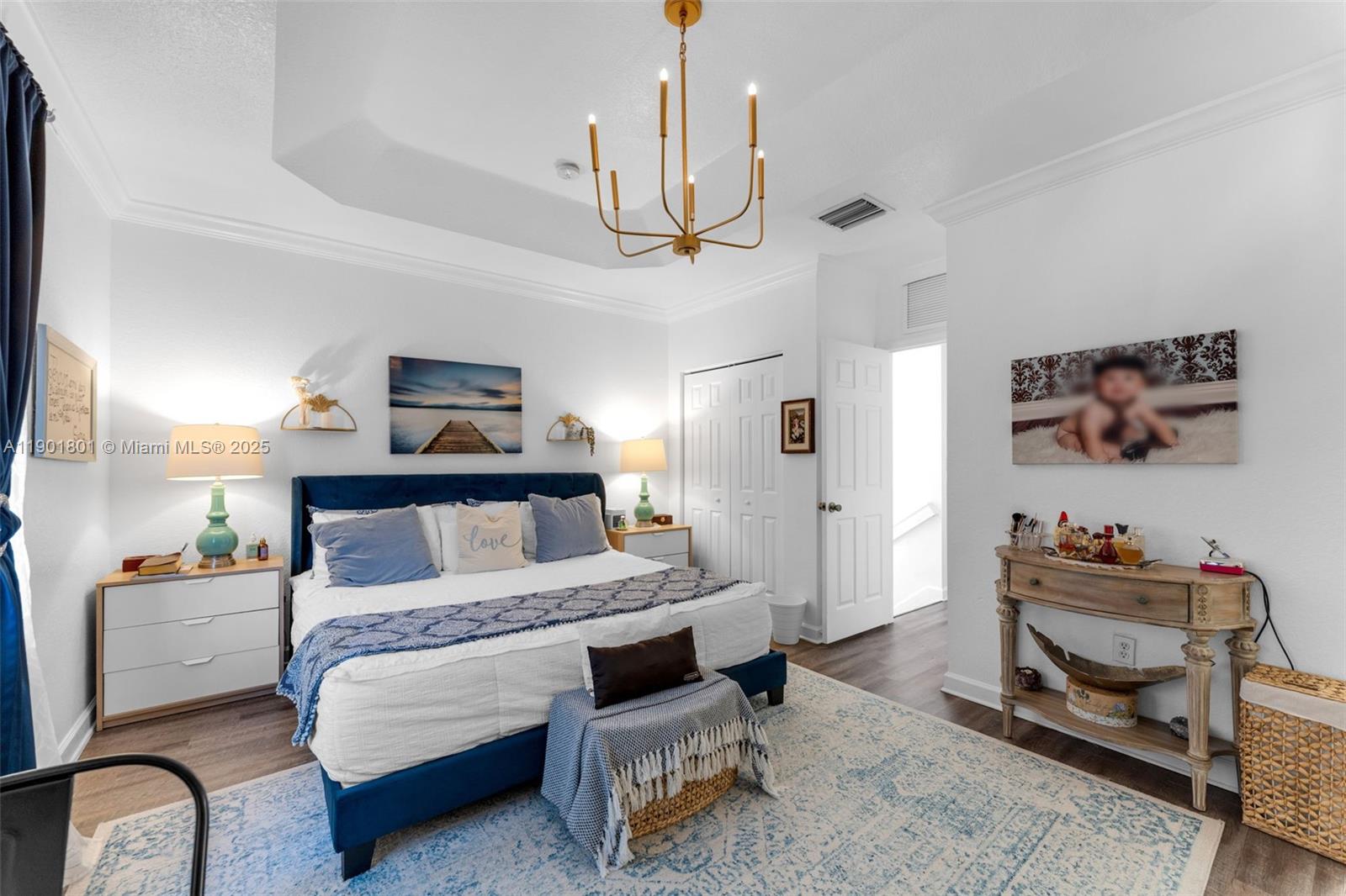 1595 Northeast 33rd Road, Unit 1123 Homestead, FL 33033 - Photo 18 of 34 a bedroom with furniture and a chandelier