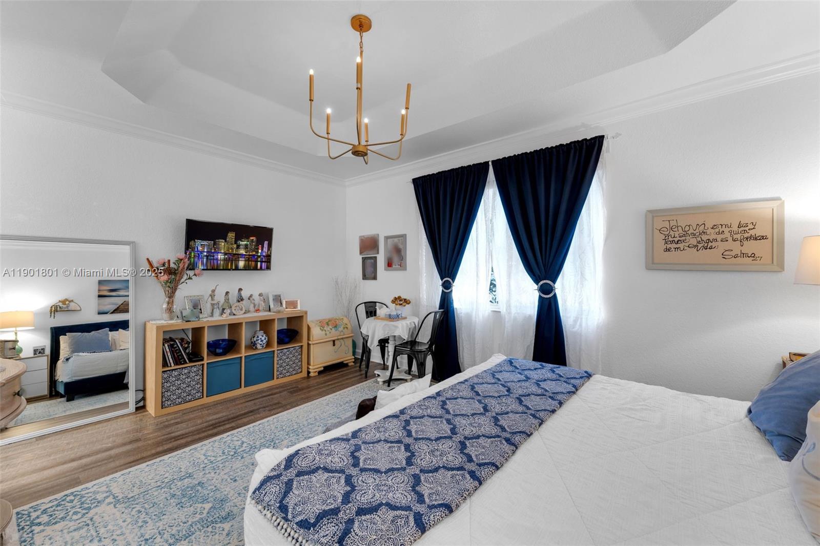 1595 Northeast 33rd Road, Unit 1123 Homestead, FL 33033 - Photo 19 of 34 a bedroom with a large bed and a chandelier