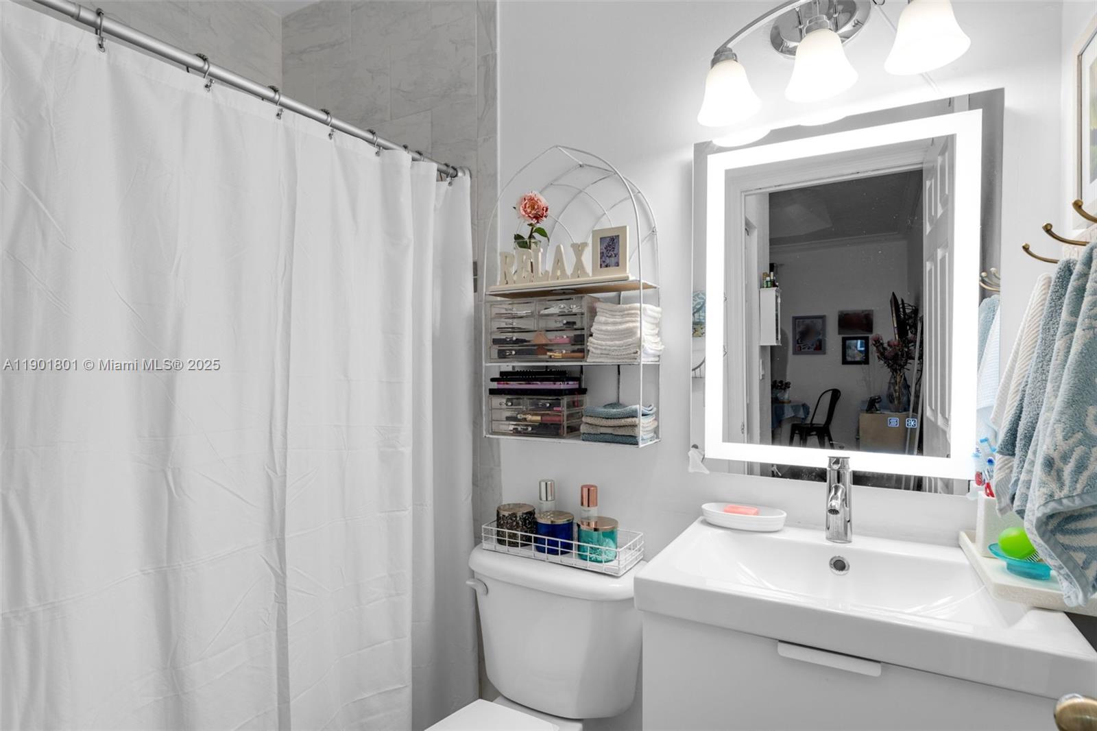 1595 Northeast 33rd Road, Unit 1123 Homestead, FL 33033 - Photo 20 of 34 a bathroom with a sink a mirror a vanity and a shower