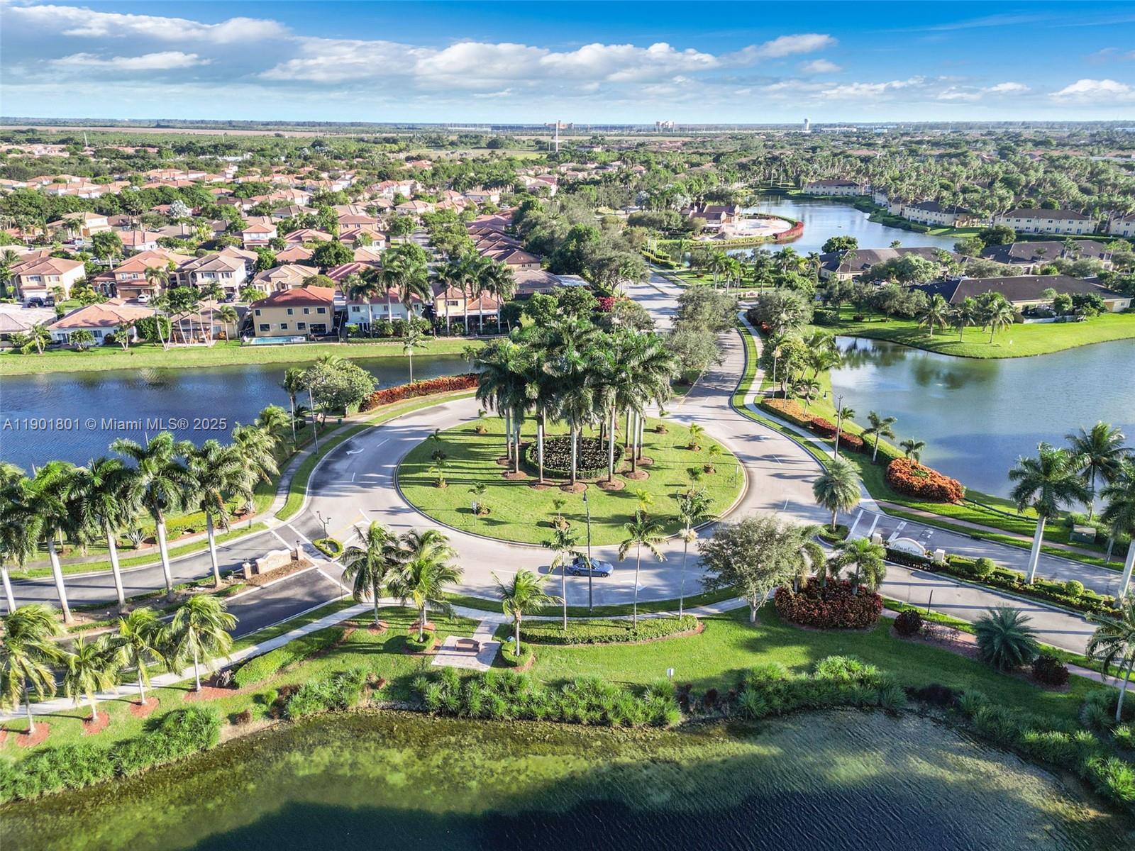 1595 Northeast 33rd Road, Unit 1123 Homestead, FL 33033 - Photo 2 of 34 an aerial view of residential houses with outdoor space and lake view