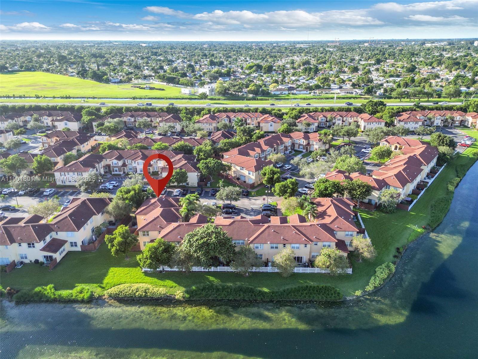1595 Northeast 33rd Road, Unit 1123 Homestead, FL 33033 - Photo 29 of 34 an aerial view of residential houses with outdoor space and swimming pool